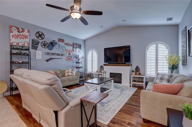 living room with visible vents, ceiling fan, wood finished floors, and a wealth of natural light