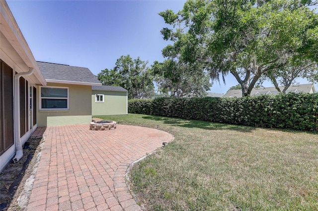 view of yard featuring a patio area and an outdoor fire pit