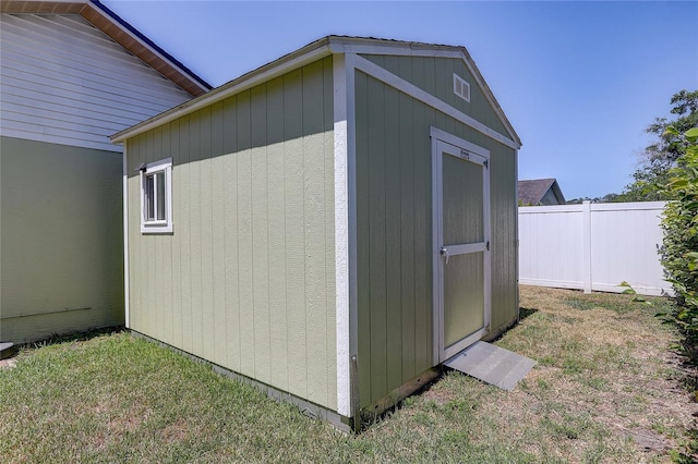 view of shed featuring fence