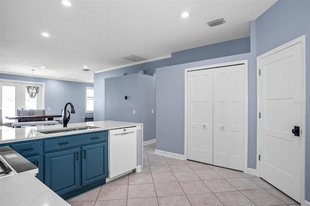 kitchen featuring blue cabinets, visible vents, white dishwasher, light countertops, and a sink