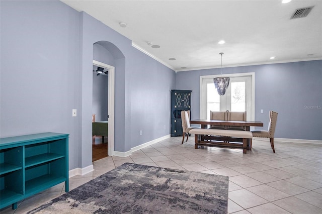 dining room with visible vents, crown molding, baseboards, recessed lighting, and arched walkways