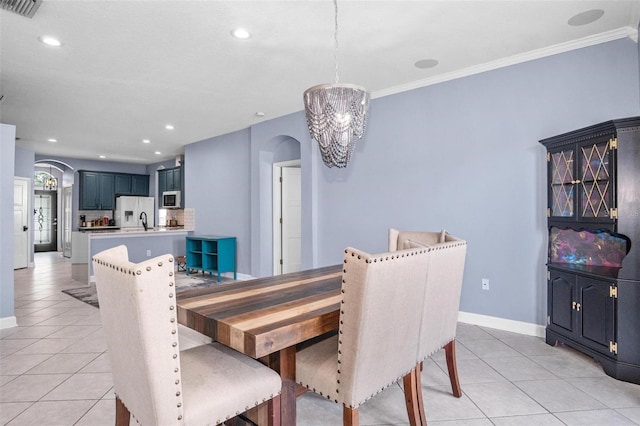dining space featuring arched walkways, baseboards, visible vents, and light tile patterned floors