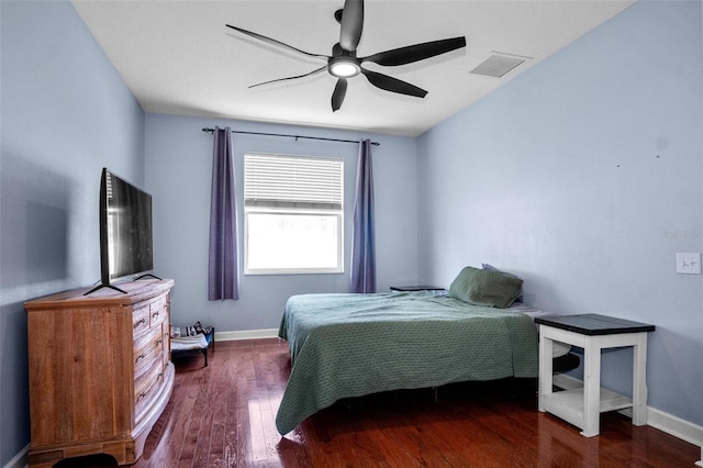 bedroom featuring a ceiling fan, baseboards, visible vents, and wood finished floors