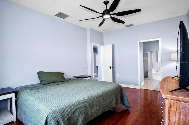 bedroom featuring connected bathroom, a ceiling fan, wood finished floors, and visible vents