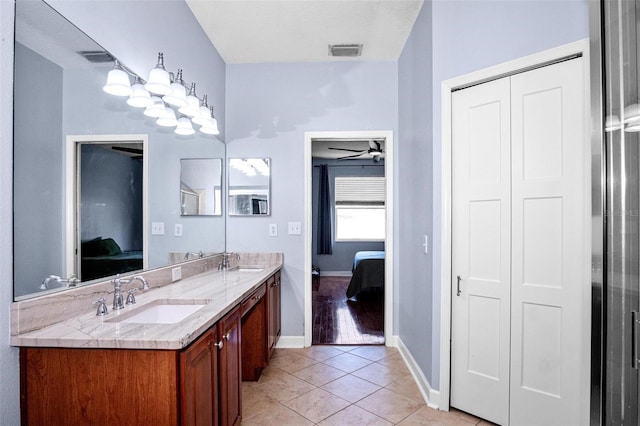 bathroom with ensuite bathroom, a sink, visible vents, and double vanity