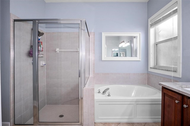 full bathroom with vanity, a stall shower, and a bath