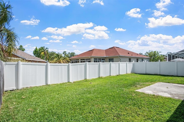 view of yard with a fenced backyard and a patio area