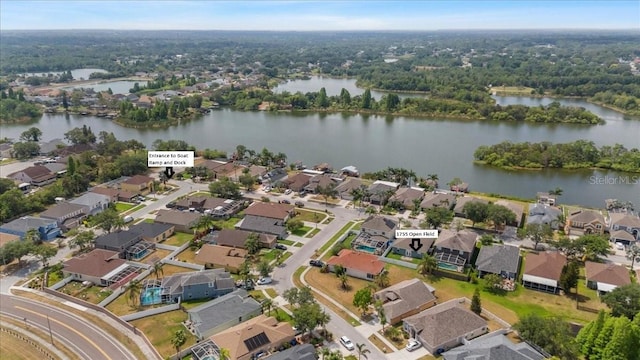 drone / aerial view with a water view and a residential view