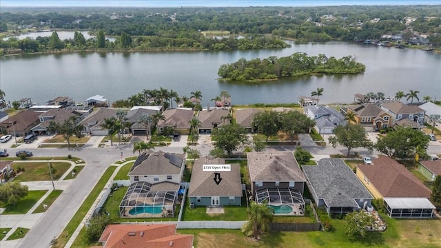 birds eye view of property featuring a water view and a residential view