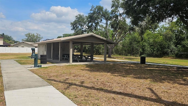 view of home's community featuring a lawn, fence, and a gazebo