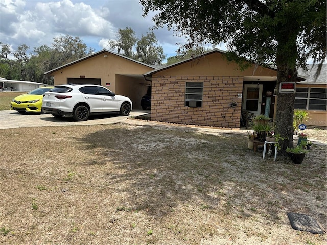 view of home's exterior with concrete driveway, an attached garage, and stone siding