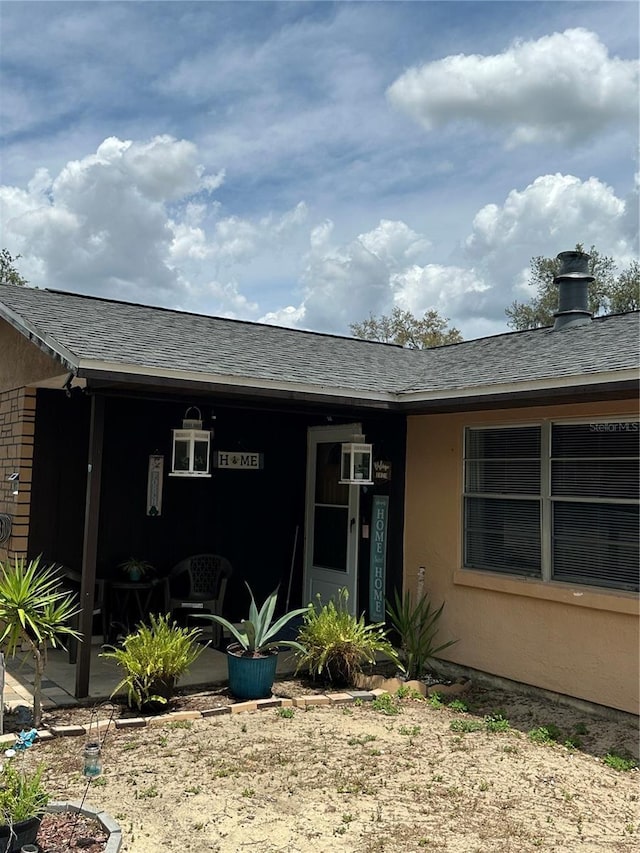 exterior space featuring a shingled roof