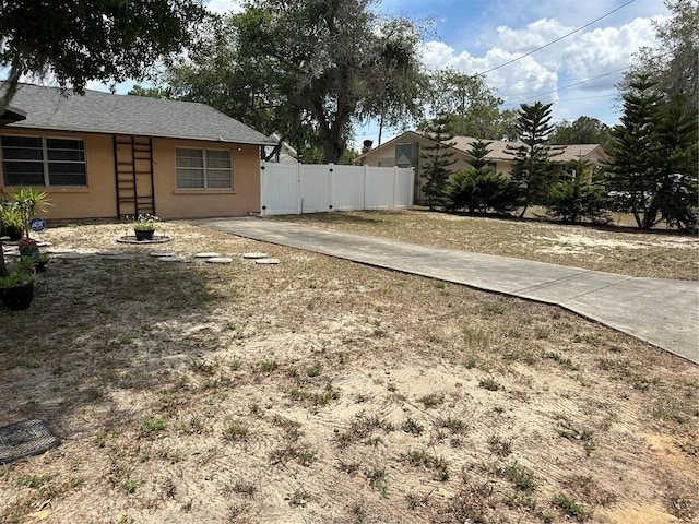 view of yard with fence and a gate