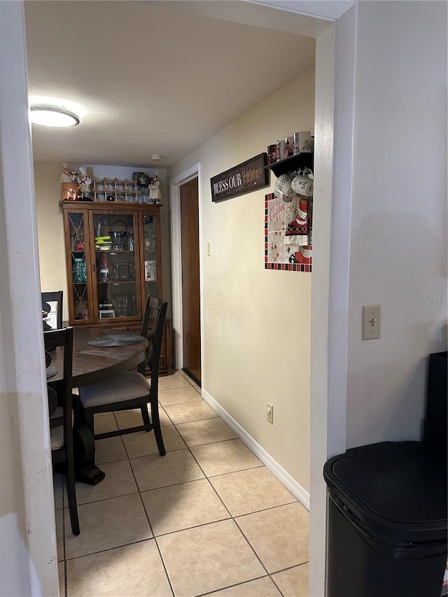 dining area with baseboards and light tile patterned floors