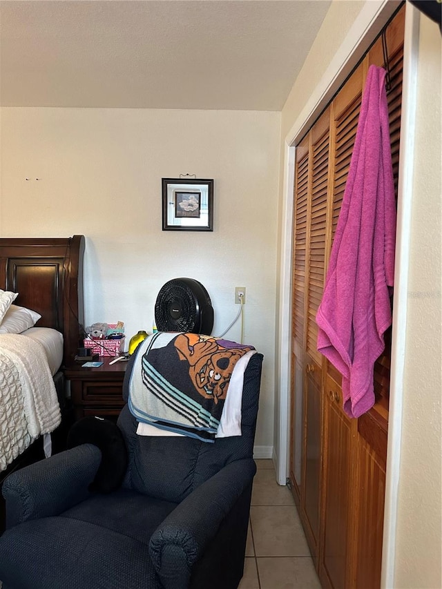 bedroom with a closet and light tile patterned floors