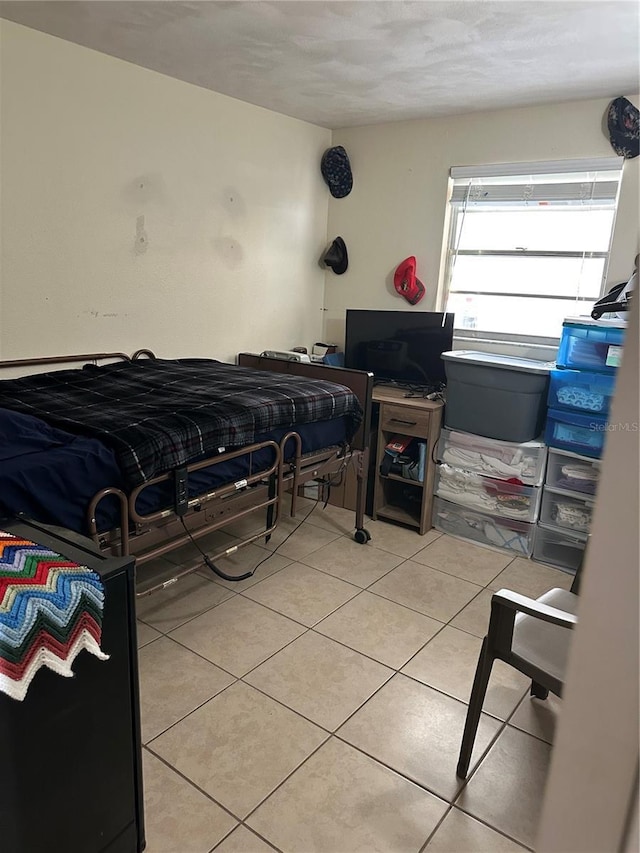 bedroom with light tile patterned floors