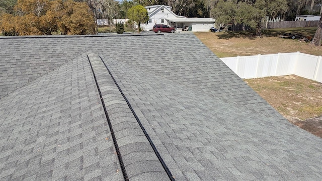 details with roof with shingles and fence