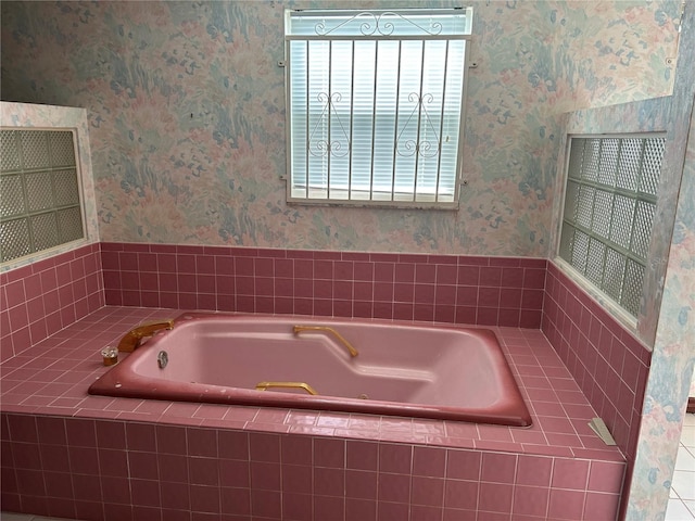 full bathroom featuring wallpapered walls and a bath