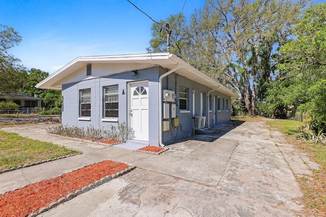 view of outbuilding featuring fence and driveway