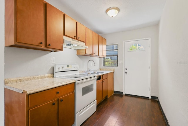 kitchen with a sink, light countertops, dark wood finished floors, under cabinet range hood, and white electric range