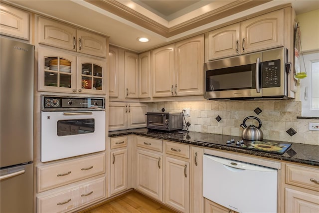 2202 Donato Dr, Belleair Beach, FL 33786 - kitchen featuring a toaster, a warming drawer, dark stone countertops, appliances with stainless steel finishes, and backsplash