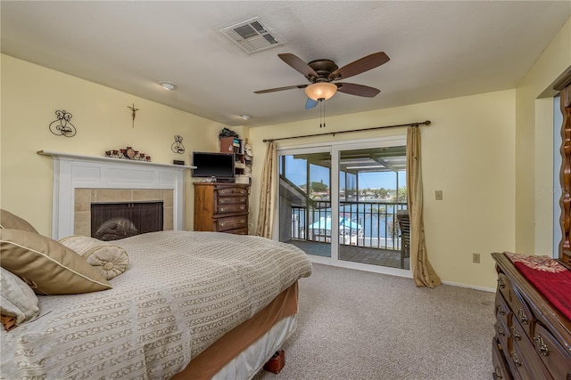 2202 Donato Dr, Belleair Beach, FL 33786 - carpeted bedroom with a ceiling fan, access to exterior, visible vents, a fireplace, and baseboards