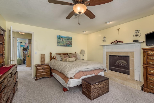2202 Donato Dr, Belleair Beach, FL 33786 - bedroom featuring ceiling fan, light colored carpet, and a tile fireplace