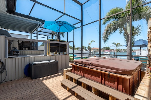 2202 Donato Dr, Belleair Beach, FL 33786 - view of patio with a covered hot tub, glass enclosure, a water view, and outdoor dry bar
