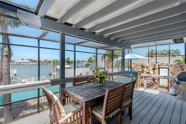 2202 Donato Dr, Belleair Beach, FL 33786 - sunroom / solarium featuring outdoor dining area, a water view, beam ceiling, and a healthy amount of sunlight
