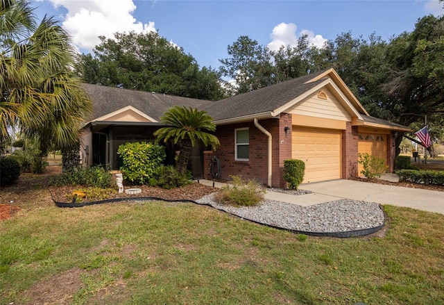 ranch-style home featuring concrete driveway, brick siding, a front yard, and a garage