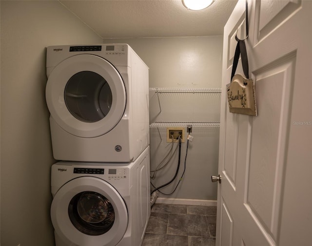 laundry room with laundry area and stacked washer / dryer