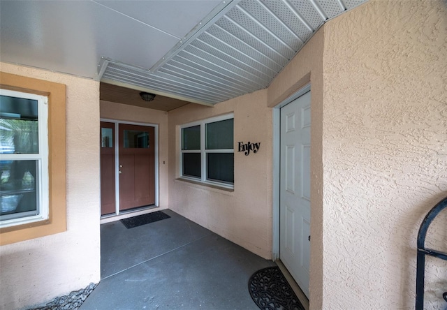 doorway to property with stucco siding