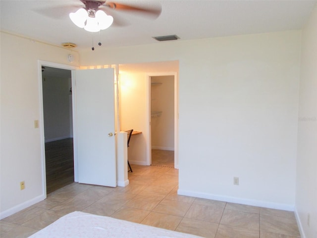 3311 Teeside Dr, New Port Richey, FL 34655 - unfurnished bedroom with a walk in closet, a ceiling fan, visible vents, baseboards, and a closet
