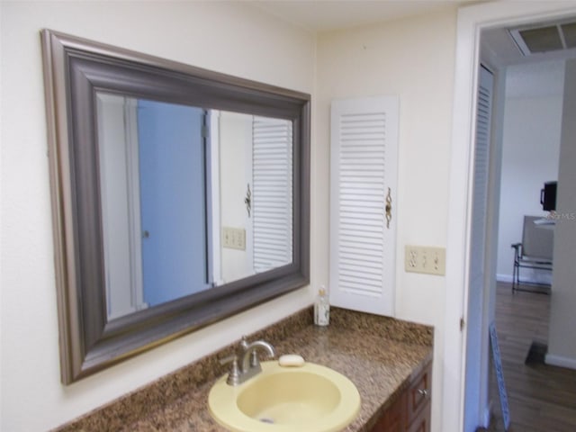 3311 Teeside Dr, New Port Richey, FL 34655 - bathroom featuring visible vents, wood finished floors, and vanity