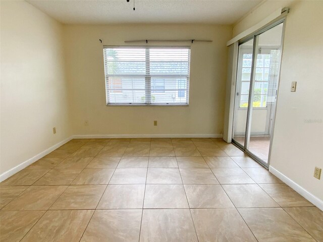 3311 Teeside Dr, New Port Richey, FL 34655 - unfurnished room featuring healthy amount of natural light and light tile patterned floors