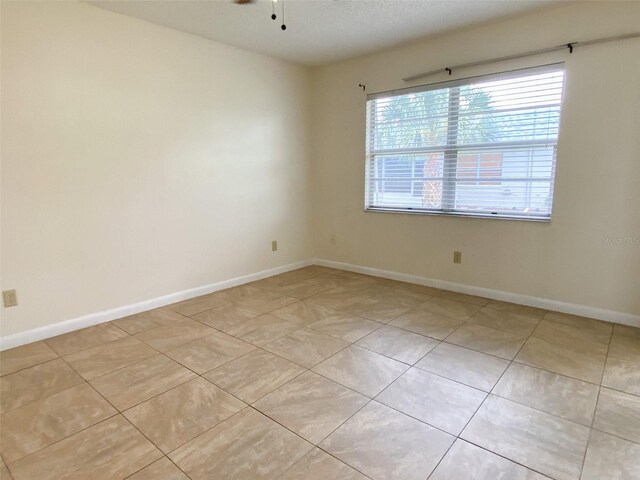 3311 Teeside Dr, New Port Richey, FL 34655 - spare room with light tile patterned floors and a ceiling fan