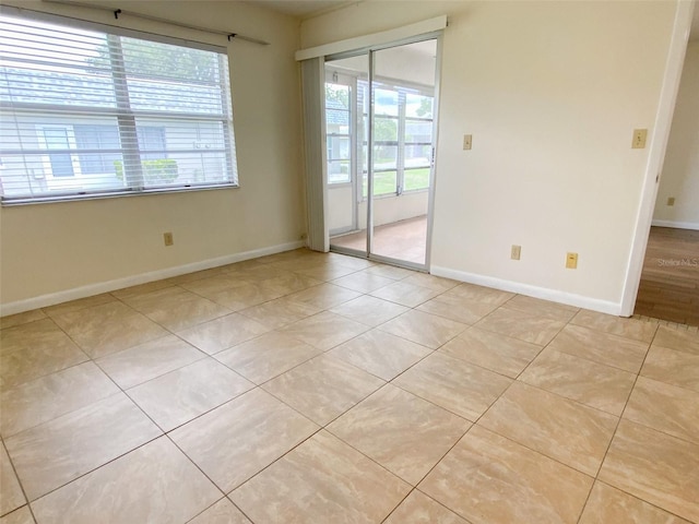 3311 Teeside Dr, New Port Richey, FL 34655 - unfurnished room featuring healthy amount of natural light and light tile patterned floors