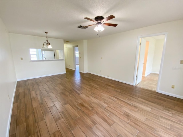 3311 Teeside Dr, New Port Richey, FL 34655 - unfurnished living room featuring wood finished floors and a ceiling fan