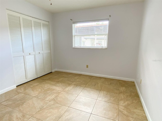 3311 Teeside Dr, New Port Richey, FL 34655 - unfurnished bedroom featuring a closet and light tile patterned floors