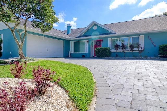 ranch-style home with decorative driveway, a garage, roof with shingles, and stucco siding