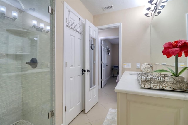 full bath featuring visible vents, vanity, tile patterned flooring, and a shower stall