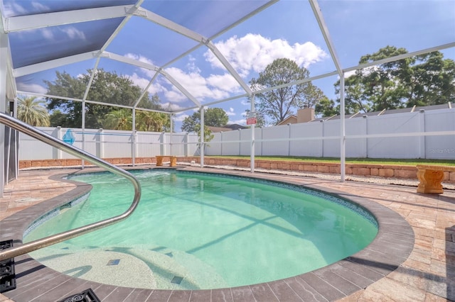 view of pool featuring a fenced in pool, a fenced backyard, a patio area, and a lanai