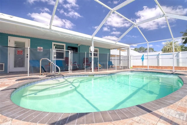 view of swimming pool featuring fence, a fenced in pool, a lanai, and a patio area