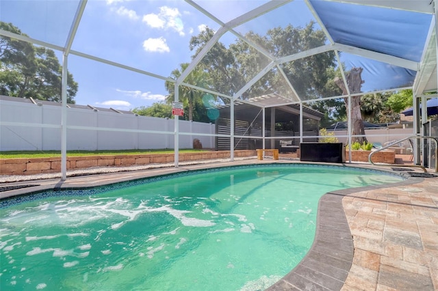 view of pool with a fenced backyard, a fenced in pool, and a lanai