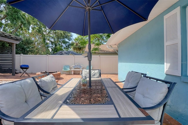view of patio with fence and outdoor dining area