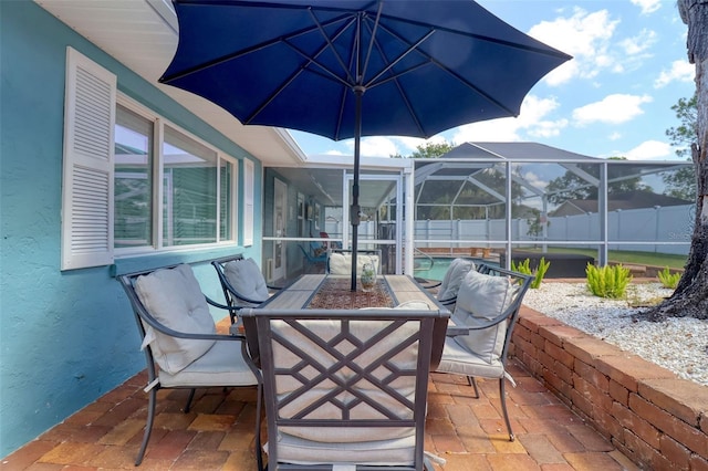 view of patio / terrace featuring glass enclosure, fence, and a fenced in pool