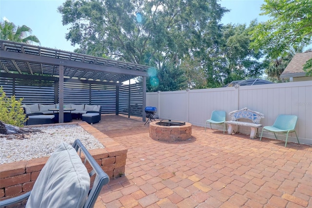 view of patio featuring a fenced backyard, an outdoor living space with a fire pit, and a pergola