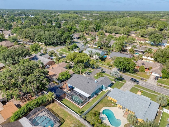 birds eye view of property featuring a residential view and a wooded view