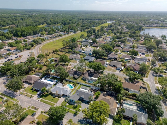 aerial view featuring a water view, a residential view, and a forest view