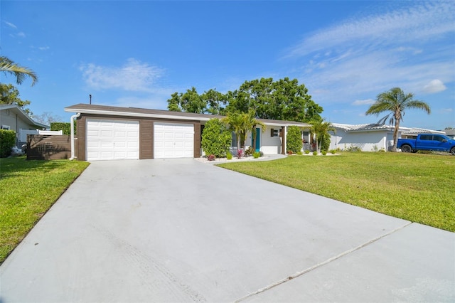 ranch-style house featuring an attached garage, driveway, and a front lawn